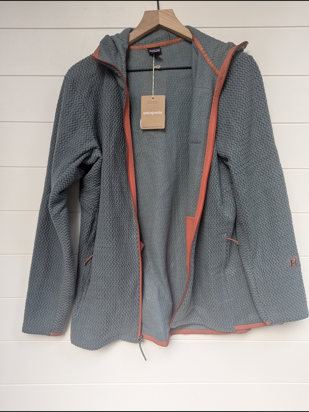 Patagonia women's full-zip hoodie in muted teal with rust trim